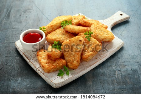 Hash brown potato with ketchup on white wooden board Royalty-Free Stock Photo #1814084672