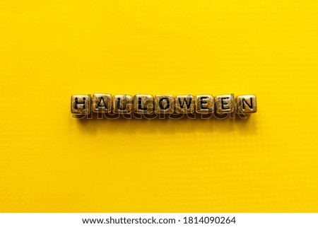 Halloween inscription on the cubes. Halloween title with yellow background. Close-up with place for text.