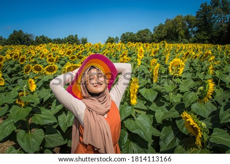 Muslim teenager pose at sunflower farm in Canada