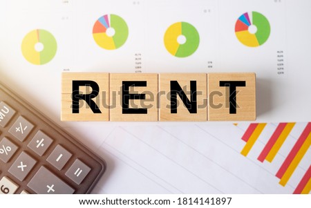 word rent on wooden cubes business graph and diagram background estate insurance concept, calculator