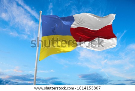 Large Flag Of the Ukrain and white red white flag of Belarus waving in the wind