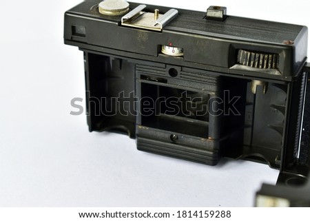 dusty old camera with open back cover