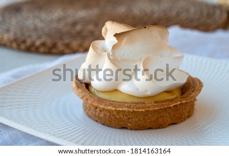 One piece of lemon tart with white eggs meringue from French pastry shop