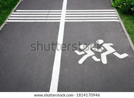 road with white dividing line, road signs, bike path with pedestrian warning sign