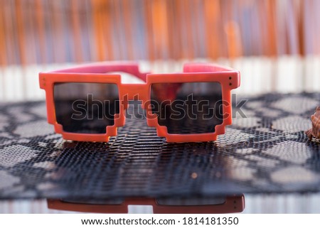Pixel sunglasses model with black lenses closeup in a summer day. Selective focus. High quality photo
