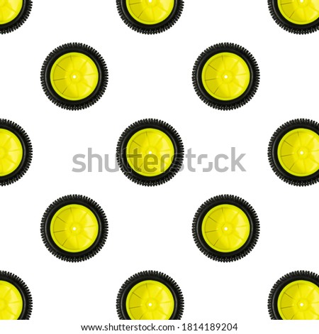 Close up view pattern of mini size yellow plast wheel with black tire isolated on white background. Radio controlled cars concept.