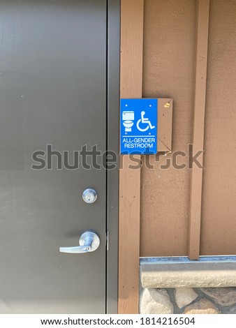 Blue and white all-gender restroom sign