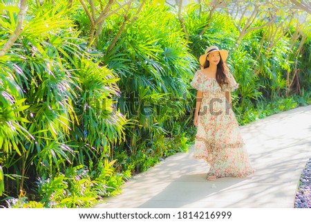 Portrait beautiful young asian woman walking with happy enjoy around outdoor garden view