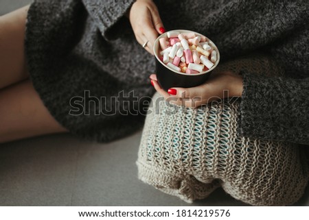 Cozy winter weekend, home scene, hygge concept. Warming hygge mood. Woman enjoy hot chocolate with marshmallows