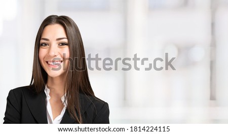 Portrait of a young smiling businesswoman, bright background banner