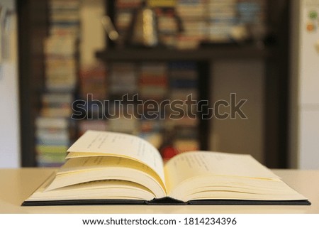 A close up shot of a book opened on a table in the reading room selective focus and shallow depth of field