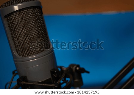 
black studio microphone on subject with its black metal arm