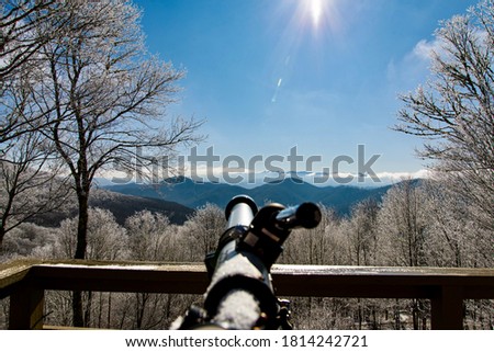 Picture of a telescope looking out towards Mount Mitchell and the Blue Ridge Mountains in North Carolina outside of Asheville.