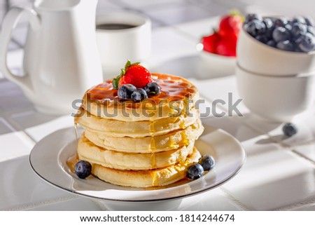 breakfast of Waffles drizzled with syrup and fruits Royalty-Free Stock Photo #1814244674