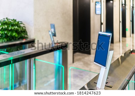 turnstile gate in office building with digital facial scaner. Royalty-Free Stock Photo #1814247623
