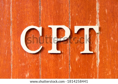 Alphabet letter in word  CPT (Abbreviation of Carriage Paid To) on old red color wood plate background