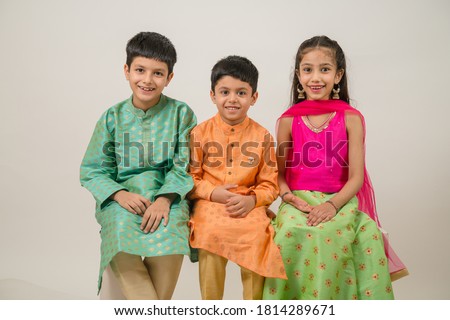 Little kids wearing tradional indian dress enjoying Indian festival  Royalty-Free Stock Photo #1814289671
