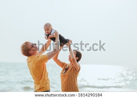 Happy family on the beach.  Father, mother and baby having fun on summer vacation. Holiday travel concept