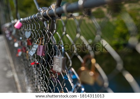 a lot of colorful love padlocks on a bridge some blurry some sharp