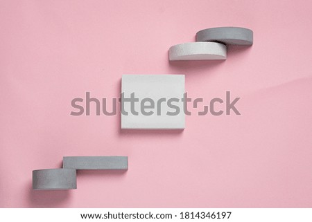 Top view of geometric shaped on pastel pink background. modern style.