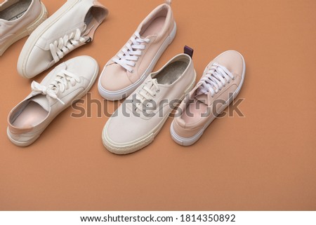 Flat lay set of composition with stylish shoes on brown background


