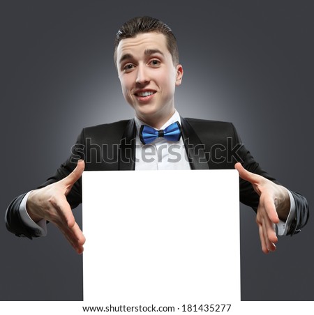 Young man holding a whiteboard. Concept - a demonstration of achievements in business, graphic ads.