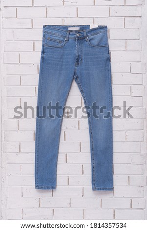 blue jeans on hanging on wall background,