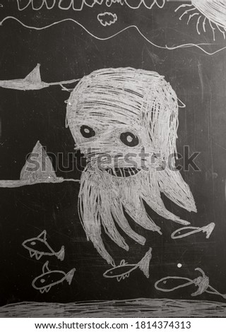child chalk drawing of octopus under the sea on the black board
