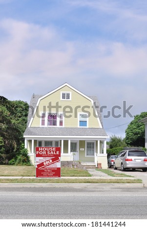 Real Estate Sold (another success let us help you buy sell your next home) Sale Sign Suburban Gambrel Style Home Residential neighborhood usa blue sky clouds