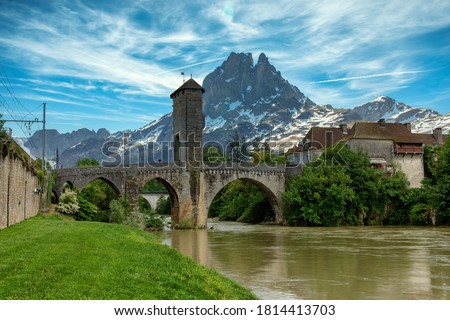a bridge over river Gave de Pau in Orthez and Pic du midi Ossau - France