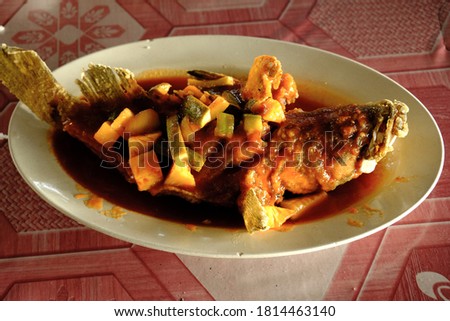 Selective focus picture of sweet and sour grouper in the plate serve in the restaurant.