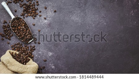 coffee beans in a sack on dark background, top view, copy space