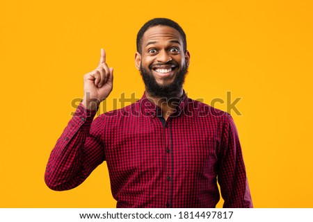 Great Idea Concept. Young Funny African American Man Pointing Finger Up. Excited Black Guy Got Solution To His Problem, Having Aha Moment, Isolated On Yellow Studio Background. Wow, Eureka