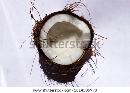 half coconut on a white background, top view.
