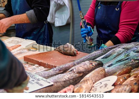 Buying fresh fish at the Atarazanas market hall in Malaga, Spain