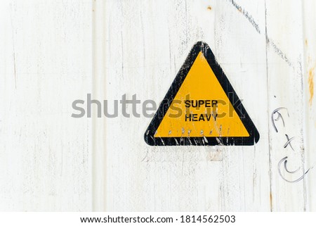 White Container wall Old metal texture with Yellow triangle sign Super Heavy close up