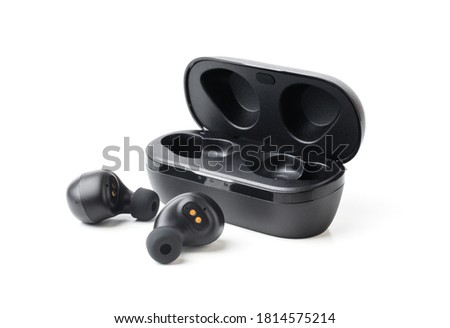 Wireless black bluetooth earphones with contactless charging isolated close-up on a white background Royalty-Free Stock Photo #1814575214