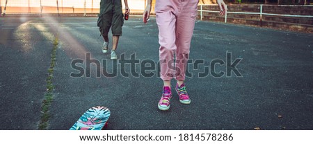 Teen male and female legs with skate board. Banner format