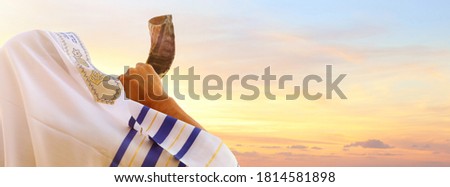 Jewish man blowing the Shofar (horn) of Rosh Hashanah (New Year). Religious symbol Royalty-Free Stock Photo #1814581898