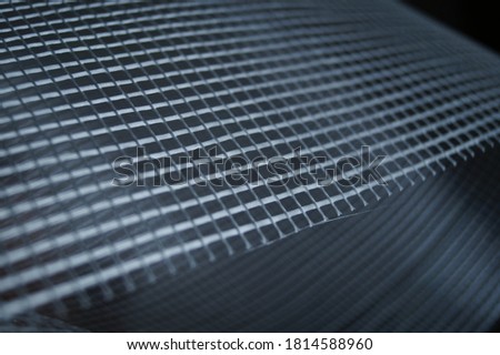 The surface of the gray plastic mesh. Close-up. Background. Selective focus.