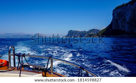 Trip with a yacht on blue sea among islands in Italy 