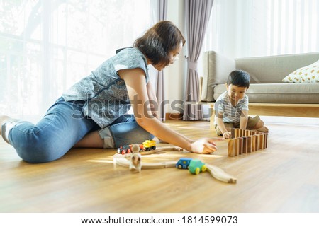 Son and mother play toys together Enhance learning development Show love in the family Strengthen relationship