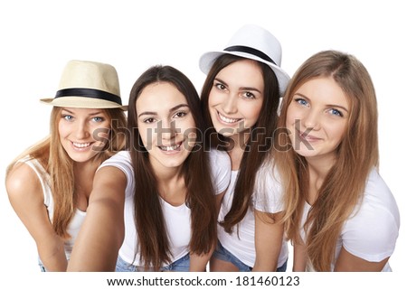 Four friends girls making self portrait with a smartphone, over white background
