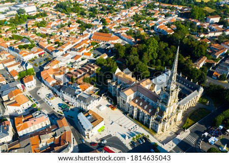 Picturesque summer view of Lucon looking out over Roman Catholic cathedral with tall Gothic bell tower, France..