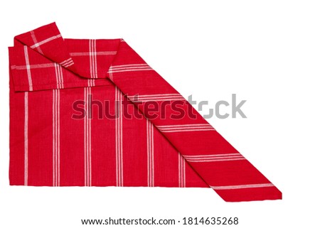 Kitchen cloth isolated. Close-up of red and white striped napkin or picnic tablecloth texture isolated on a white background. Kitchen towel.