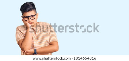 Little boy kid wearing casual clothes and glasses thinking looking tired and bored with depression problems with crossed arms. 