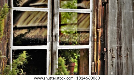 Photo of a wooden window of an old building.