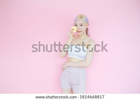 posing beautiful asian woman posing on pink background, emotions action, beauty concept and hair highlights with Make-up sponge