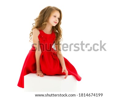 Portrait of Beautiful Preteen Girl in Red Dress Posing in Studio