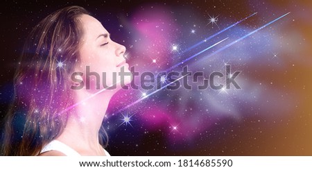 Double exposure portrait of a young woman with galaxy space inside head. Royalty-Free Stock Photo #1814685590
